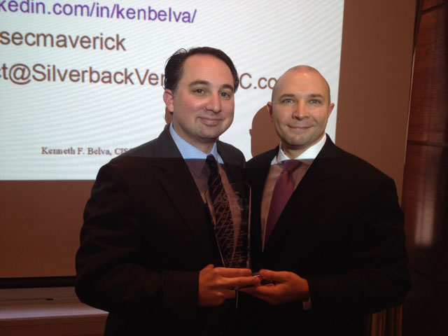 Kenneth Belva of McGraw Hill Financial receives a plaque for his presentation on the overlap between physical and cyber security environments. The award is presented at the October Monthly Luncheon by Craig Schwab, vice chair.